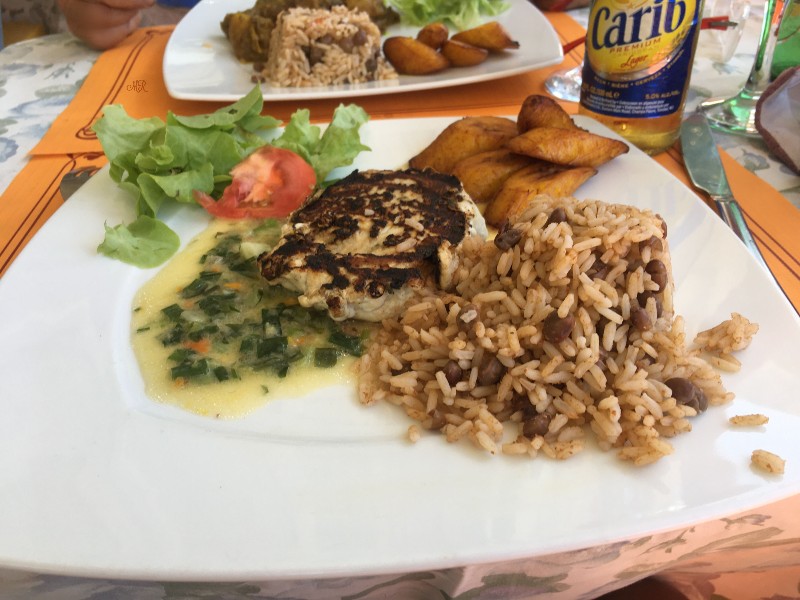 Perfect the essence of Caribbean cuisine, grilled fish, rice and peas, fried plantains and a bottle of Carib Premium beer or a Ti-Punch